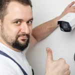 a man fixing cctv camera